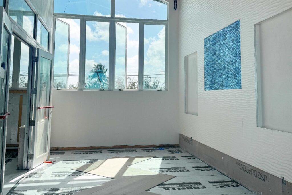 Wave tile wall and blue accent tile in the second floor elevator lobby.