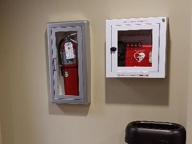 The AED next to a fire extinguisher