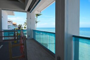 a photo of the balcony looking out onto the beach