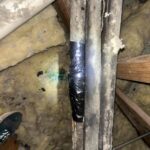 A photo of corroded refrigerant line insulation for a residential air conditioning system